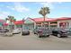 Exterior shot of shops with vibrant red roofs in a commercial plaza, with ample parking at 129 Sparrow Dr, Isle of Palms, SC 29451