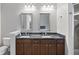 Bathroom with double vanity, granite countertop and a dark brown cabinets at 145 Pier View St # 403, Charleston, SC 29492