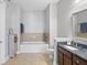 Neutral bathroom with bathtub, toilet, and vanity with dark countertop at 145 Pier View St # 403, Charleston, SC 29492