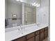 Bathroom with large mirror and double vanity, granite countertop, and plenty of storage at 145 Pier View St # 403, Charleston, SC 29492