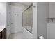 Bright and clean bathroom featuring a glass shower enclosure and a door to the restroom at 145 Pier View St # 403, Charleston, SC 29492
