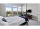 Bright bedroom with large windows, gray bed frame, and desk area with ergonomic chair at 145 Pier View St # 403, Charleston, SC 29492