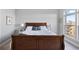 This bedroom has a large window and a nicely made bed with pillows at 145 Pier View St # 403, Charleston, SC 29492