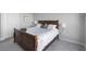 Bedroom with a large bed, white walls, and 2 lamps on the side tables at 145 Pier View St # 403, Charleston, SC 29492