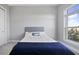 Bedroom featuring a gray upholstered bedframe with blue blanket in front of a bright window at 145 Pier View St # 403, Charleston, SC 29492