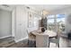 Bright dining room with a wood table, chandelier, and natural light at 145 Pier View St # 403, Charleston, SC 29492
