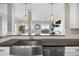 Open-concept kitchen with a view to the living room, stainless steel sink and appliances at 145 Pier View St # 403, Charleston, SC 29492