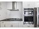 Modern kitchen with white cabinets, stainless steel appliances, granite countertops, and subway tile backsplash at 145 Pier View St # 403, Charleston, SC 29492