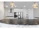 Bright kitchen features white cabinets, subway tile backsplash, stainless steel appliances, and breakfast bar at 145 Pier View St # 403, Charleston, SC 29492