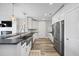 Bright modern kitchen featuring white cabinetry, granite counters, and stainless steel appliances at 145 Pier View St # 403, Charleston, SC 29492