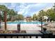 Beautiful community pool featuring lounge chairs, palm trees, and a serene outdoor ambiance at 145 Pier View St # 403, Charleston, SC 29492