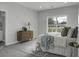 Cozy bedroom featuring neutral tones, dresser, and ample natural light from the window overlooking the yard at 1721 Pimlico Blvd, Moncks Corner, SC 29461