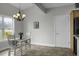 Charming dining room with tile floors, chandelier, and farmhouse table set at 1721 Pimlico Blvd, Moncks Corner, SC 29461