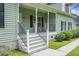 Inviting front porch with classic railing detail and view of the lush front yard at 1721 Pimlico Blvd, Moncks Corner, SC 29461