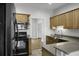Traditional kitchen featuring wood cabinetry, tile backsplash, and black appliances at 1721 Pimlico Blvd, Moncks Corner, SC 29461