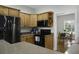 Bright kitchen features wooden cabinets, speckled countertops, and black appliances at 1721 Pimlico Blvd, Moncks Corner, SC 29461