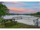 Picturesque lakeside property with picnic table and spacious dock overlooking tranquil water at sunset at 1721 Pimlico Blvd, Moncks Corner, SC 29461