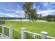 Enjoy serene waterfront views from this property with lush green grass and a deck overlooking the calm lake at 1721 Pimlico Blvd, Moncks Corner, SC 29461