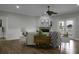 Bright living room showcasing a fireplace, ceiling fan and access to a balcony at 1721 Pimlico Blvd, Moncks Corner, SC 29461