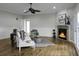 Spacious living room features a fireplace, ceiling fan, and light-colored hardwood floors at 1721 Pimlico Blvd, Moncks Corner, SC 29461