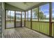 Inviting screened porch with beautiful views of the lush backyard and the serene lake at 1721 Pimlico Blvd, Moncks Corner, SC 29461