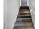 Carpeted staircase with white banister leads to the next level at 1721 Pimlico Blvd, Moncks Corner, SC 29461