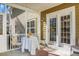 A back porch features a table and chairs and double doors to the backyard at 188 Donning Dr, Summerville, SC 29483