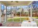 A screened-in back porch with a table and view of the fenced-in backyard at 188 Donning Dr, Summerville, SC 29483