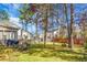 Spacious backyard with mature trees and outdoor seating for relaxing at 188 Donning Dr, Summerville, SC 29483