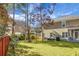 Large backyard featuring mature trees, green lawn, and outdoor seating area at 188 Donning Dr, Summerville, SC 29483