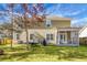 A lush backyard with trees, grass, a patio, and a screened-in porch at 188 Donning Dr, Summerville, SC 29483