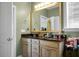 Bathroom featuring a double sink vanity with a mirror and vanity lights, and a white door at 188 Donning Dr, Summerville, SC 29483