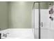Relaxing bathroom features a soaking tub with a shower and a glass door at 188 Donning Dr, Summerville, SC 29483