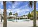 Community pool with cabanas surrounded by lush palm trees and blue skies at 188 Donning Dr, Summerville, SC 29483