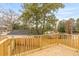 Over the deck railing is a great backyard view with privacy fence and mature trees at 2191 Helm Ave, North Charleston, SC 29405