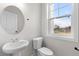 Powder room with white pedestal sink, modern faucet, and updated toilet at 2191 Helm Ave, North Charleston, SC 29405