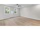 Bright bedroom with hardwood floors, ample natural light, and a ceiling fan at 2191 Helm Ave, North Charleston, SC 29405