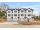 A modern townhouse complex is complete with garages, front lawns, and contemporary design at 2191 Helm Ave, North Charleston, SC 29405