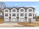 New townhouse construction features white siding, black trim, garage, and charming front entrance at 2191 Helm Ave, North Charleston, SC 29405