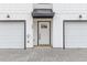 Exterior view of townhome with white siding, black accents and a two-car garage at 2191 Helm Ave, North Charleston, SC 29405