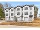 Three-story townhouses feature white siding, a garage, and are landscaped with new foliage at 2191 Helm Ave, North Charleston, SC 29405