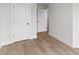 Hallway featuring hardwood floors, neutral paint and white trim with doors to bedrooms and closets at 2191 Helm Ave, North Charleston, SC 29405