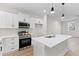Stainless steel appliances and white cabinets with island in an open concept kitchen at 2191 Helm Ave, North Charleston, SC 29405