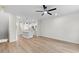 Open-concept living and kitchen area with hardwood floors, white cabinets, and modern lighting at 2191 Helm Ave, North Charleston, SC 29405