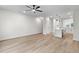 Open-concept living and kitchen area with hardwood floors, white cabinets, and modern lighting at 2191 Helm Ave, North Charleston, SC 29405