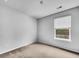 A bedroom has neutral carpet and a bright window at 246 Spencer Cir, Summerville, SC 29485