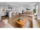 Open-concept living room with a view to the kitchen and dining area filled with natural light at 246 Spencer Cir, Summerville, SC 29485