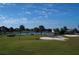 Scenic aerial view of a golf course community with a pond and lush greenery at 280 Driftwood Ln, Edisto Beach, SC 29438