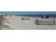 Quiet beach with privacy fencing and distant buildings, a serene escape by the ocean at 280 Driftwood Ln, Edisto Beach, SC 29438