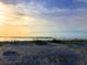 Wide sandy beach with calming waters and a beautiful sunrise, perfect for relaxation and recreation at 280 Driftwood Ln, Edisto Beach, SC 29438